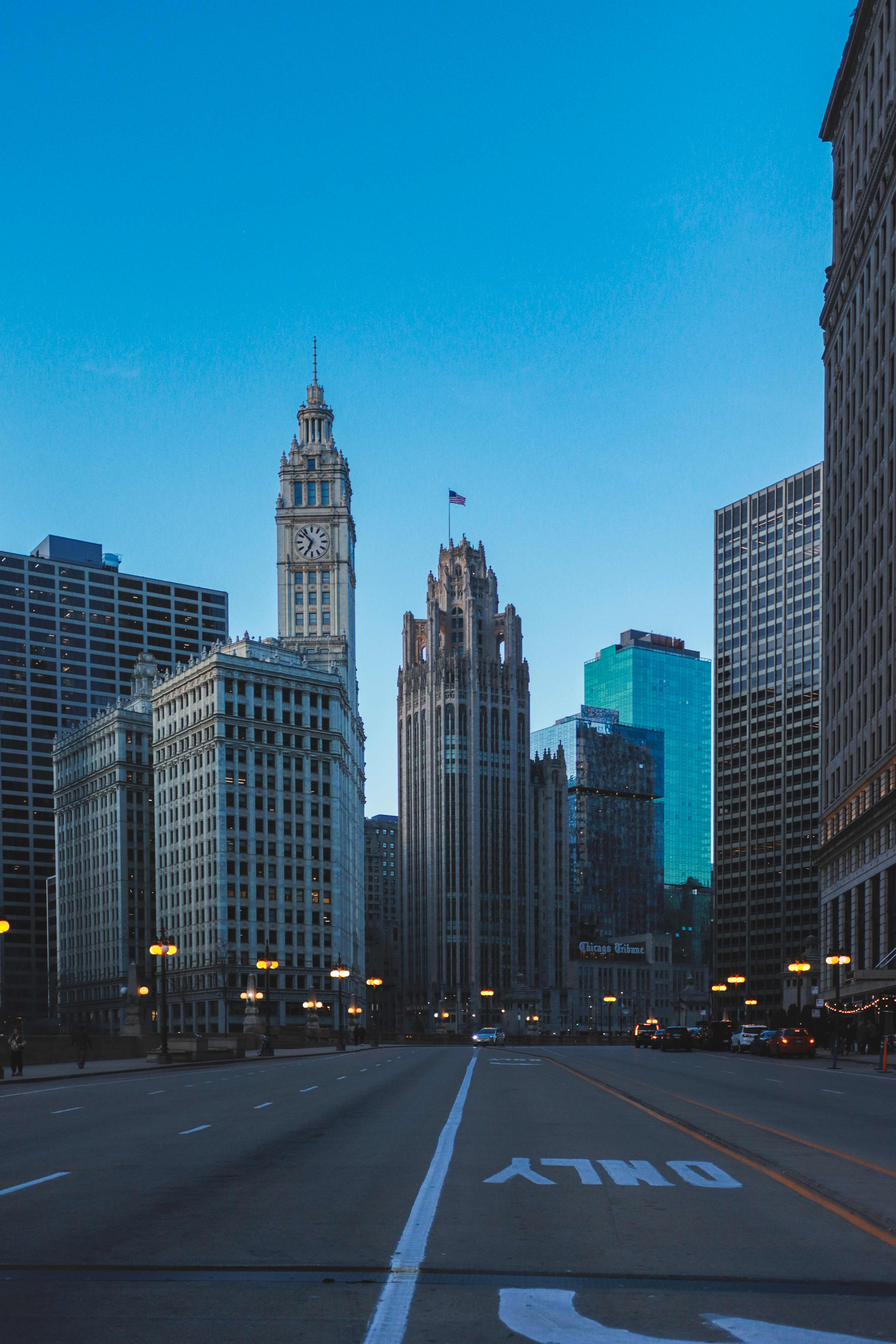 Empty Michigan Avenue at dawn — Wrigley Building and Tribune Tower ahead