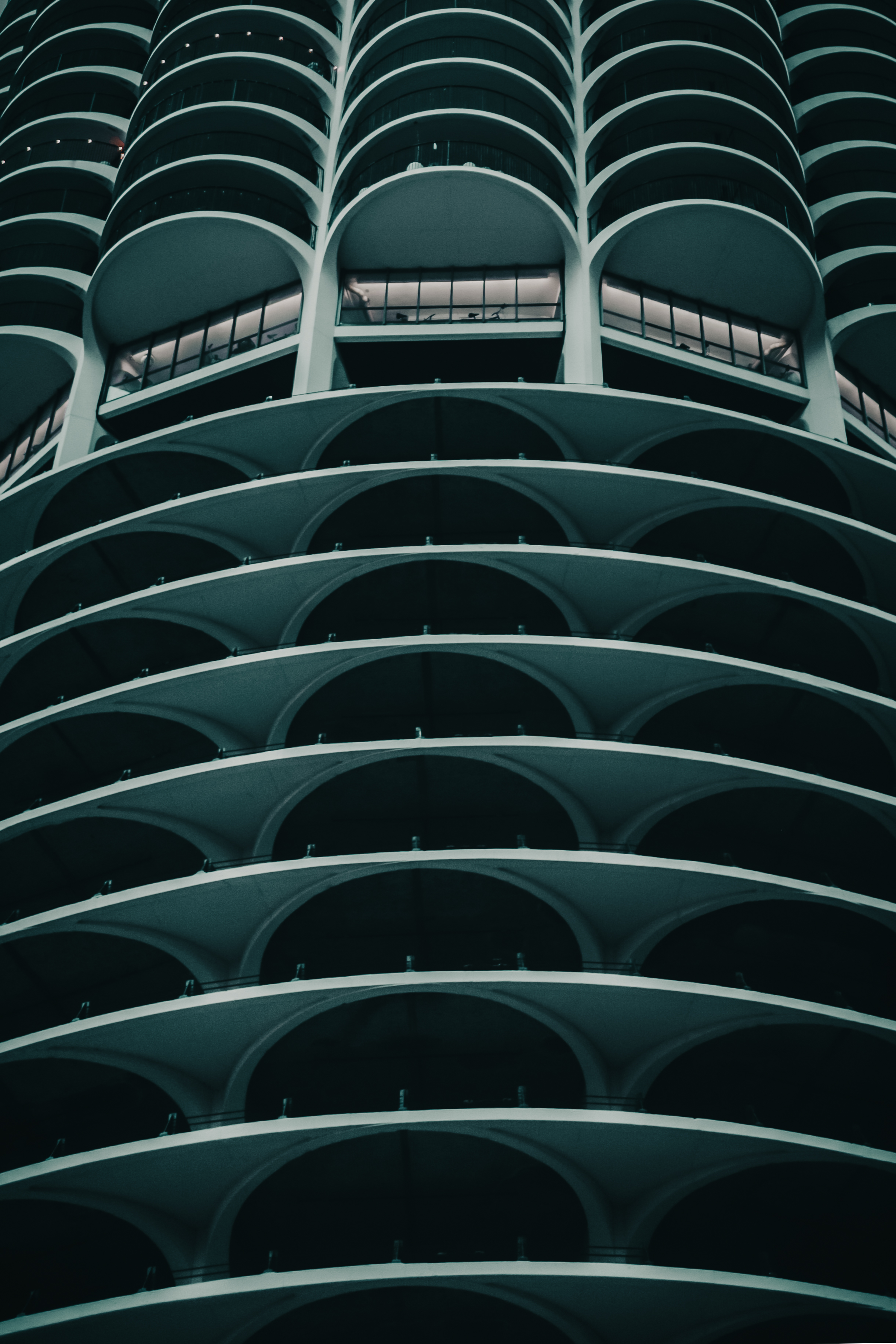 Marina City curved balconies close-up — repeating arches in deep teal