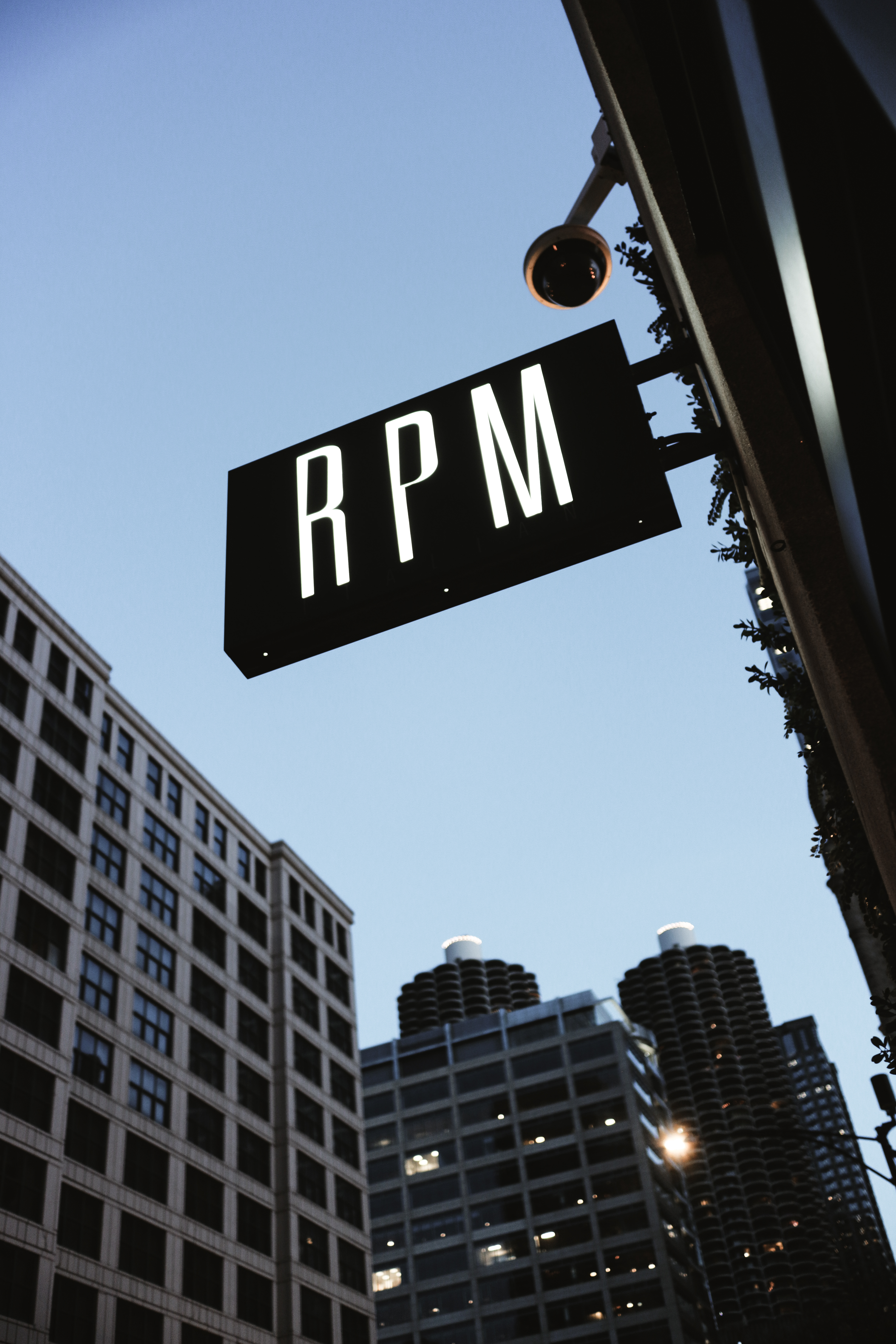 RPM Italian sign against deep blue sky — Marina City twin towers visible behind