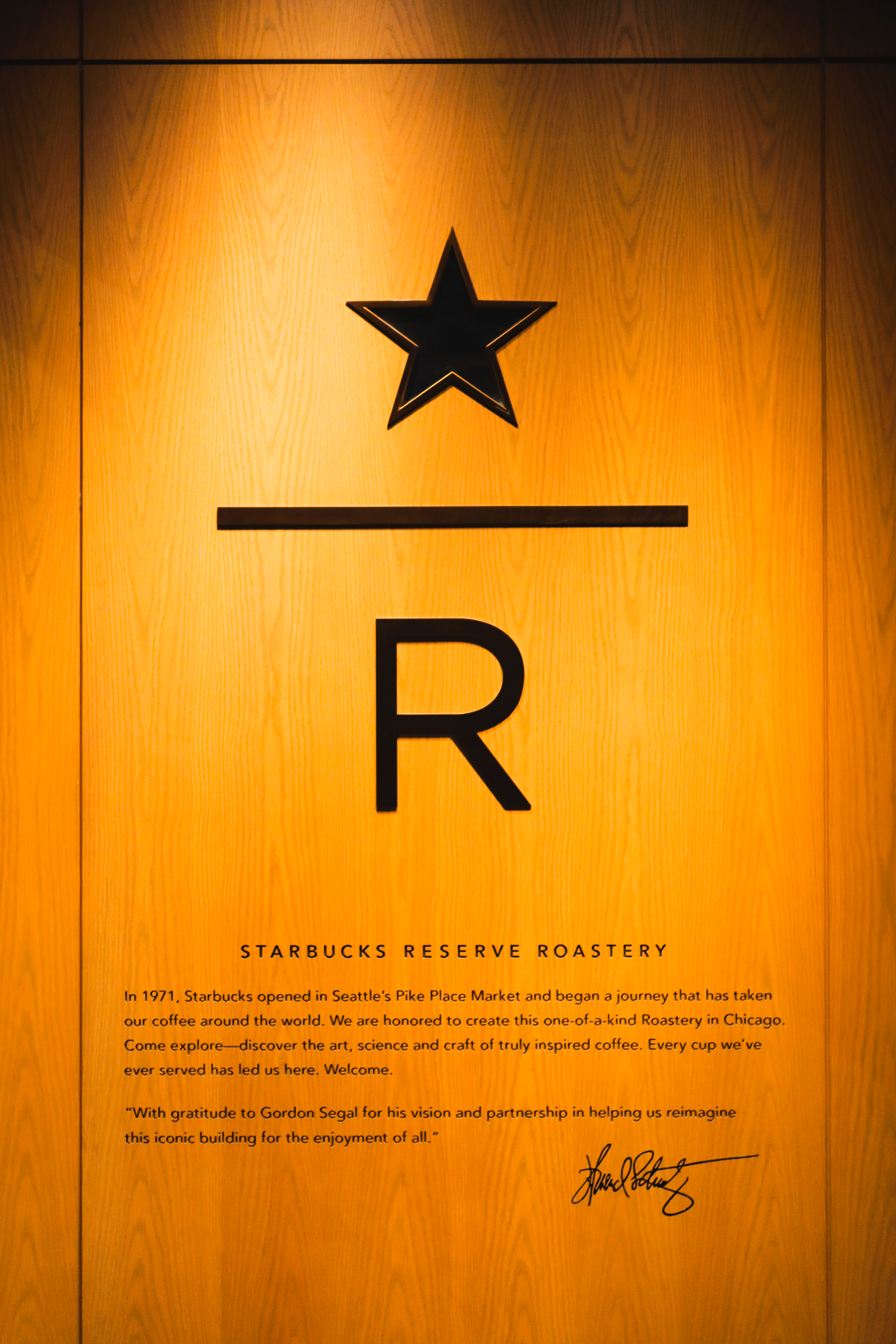 Starbucks Reserve Roastery Chicago entrance — warm wood panel with engraved star