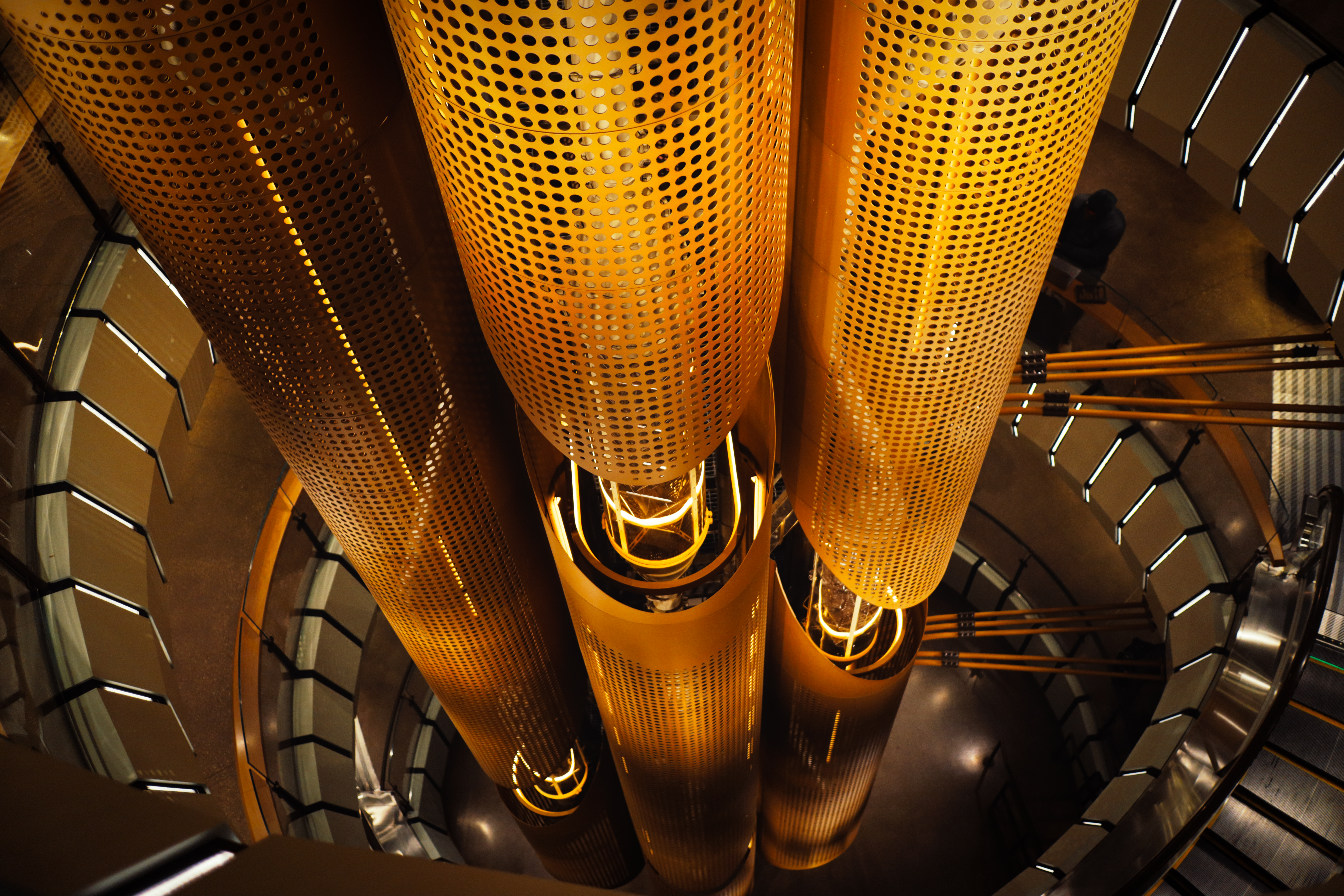 Starbucks Reserve Roastery — perforated copper roasting silos looking up from below