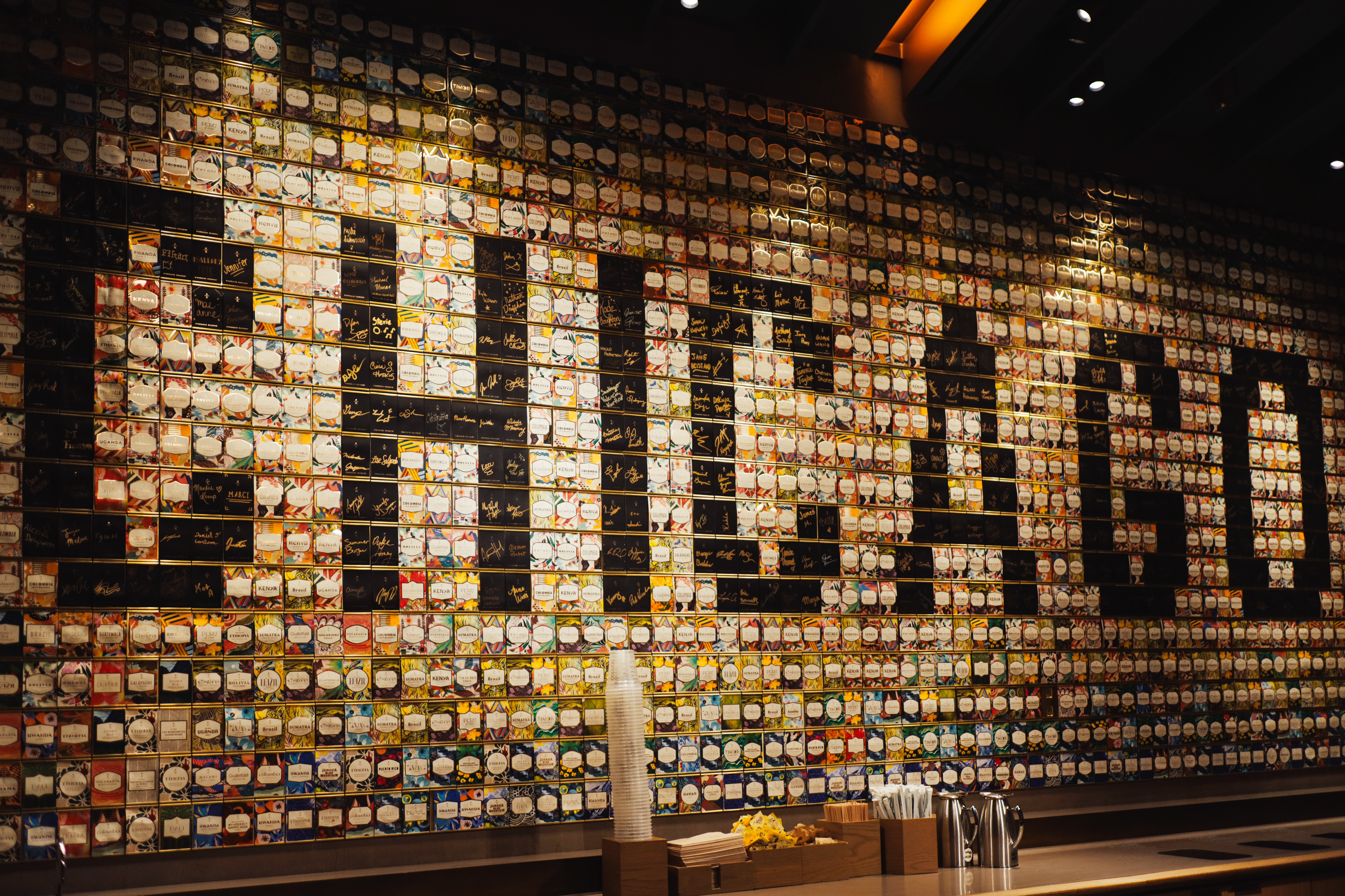 Starbucks Reserve Roastery Chicago — CHICAGO spelled in hundreds of coffee jar lids on wall