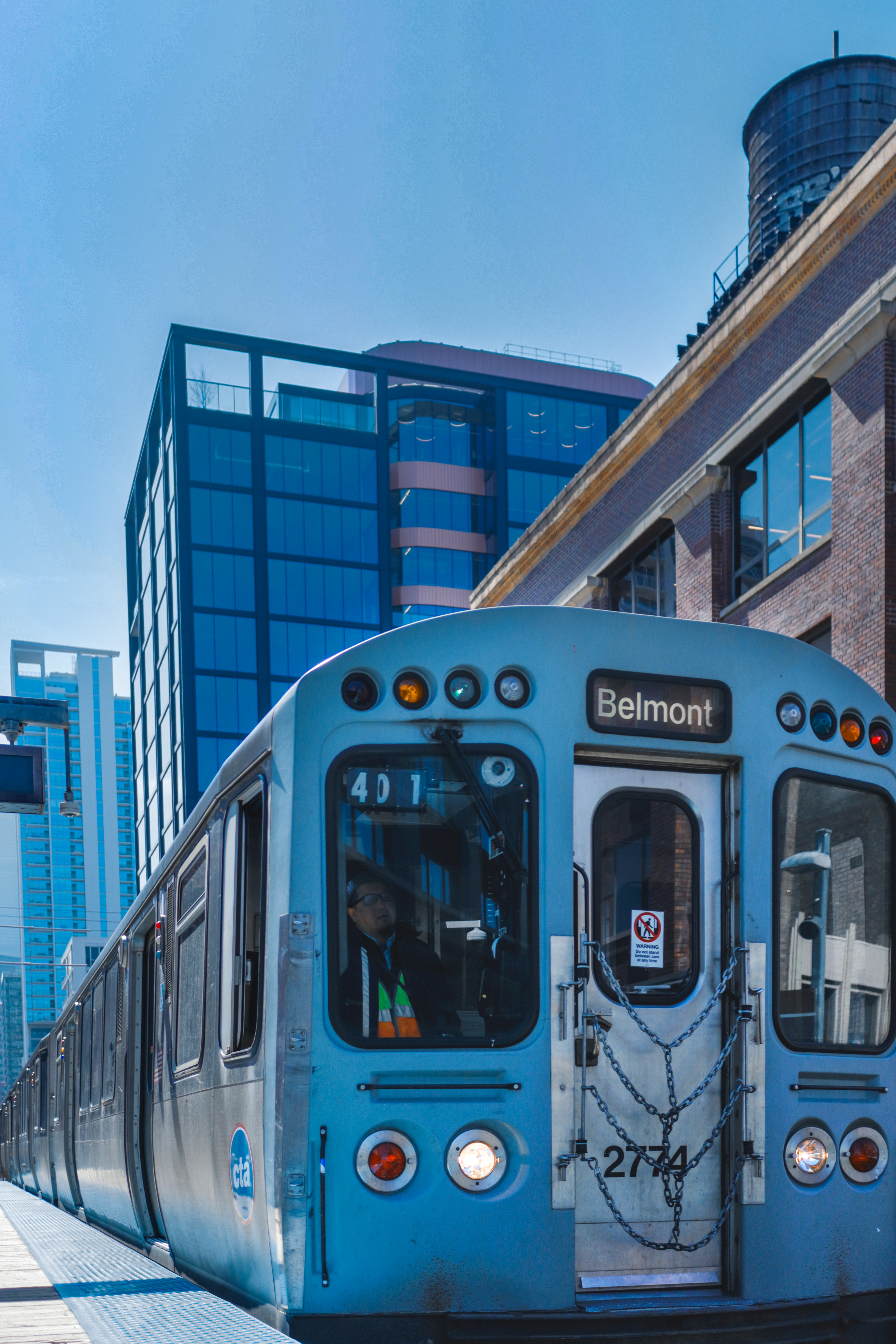 CTA Red Line train arriving at Belmont station — operator visible through front window