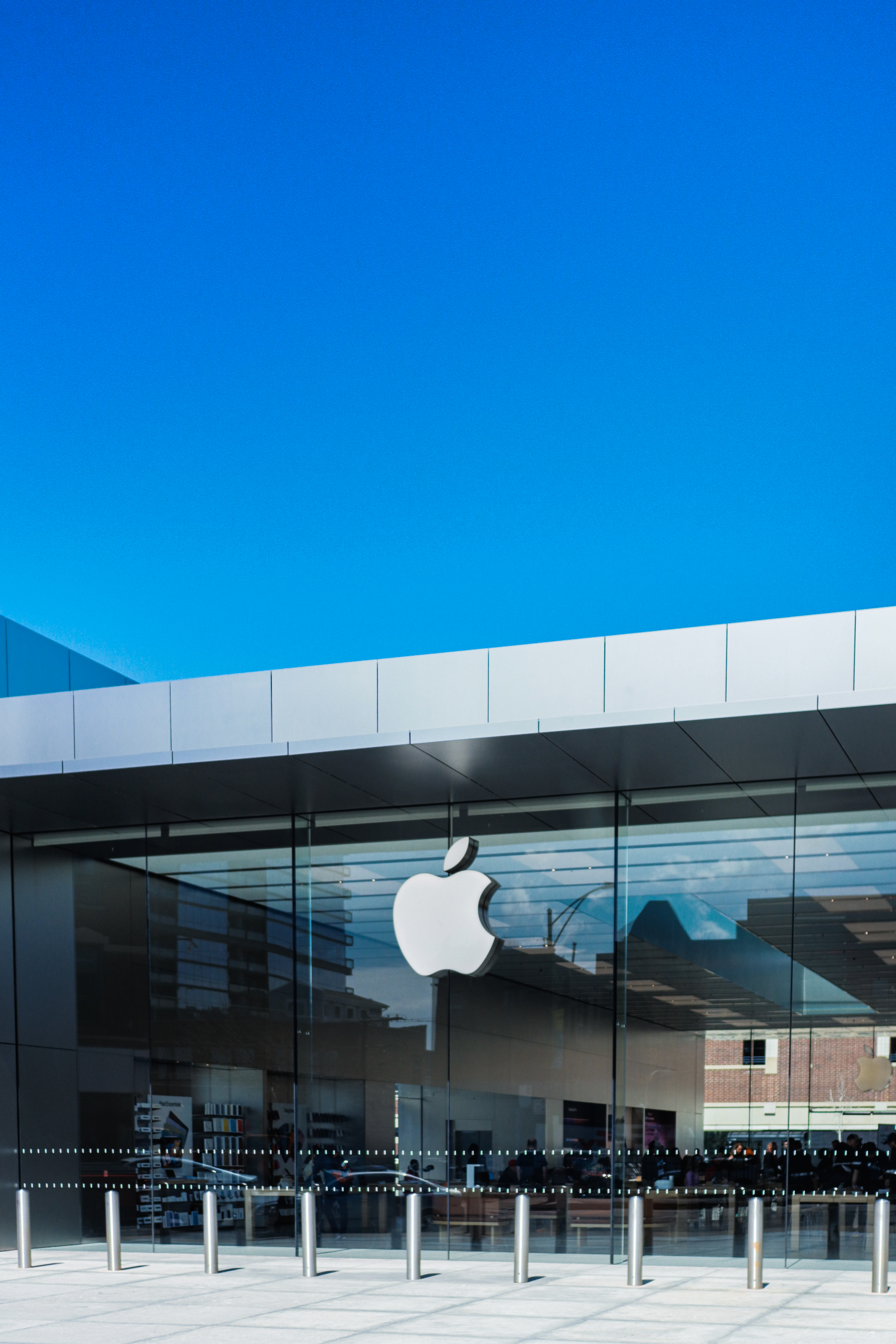 Apple Store Michigan Avenue — full-height glass facade, cobalt blue sky
