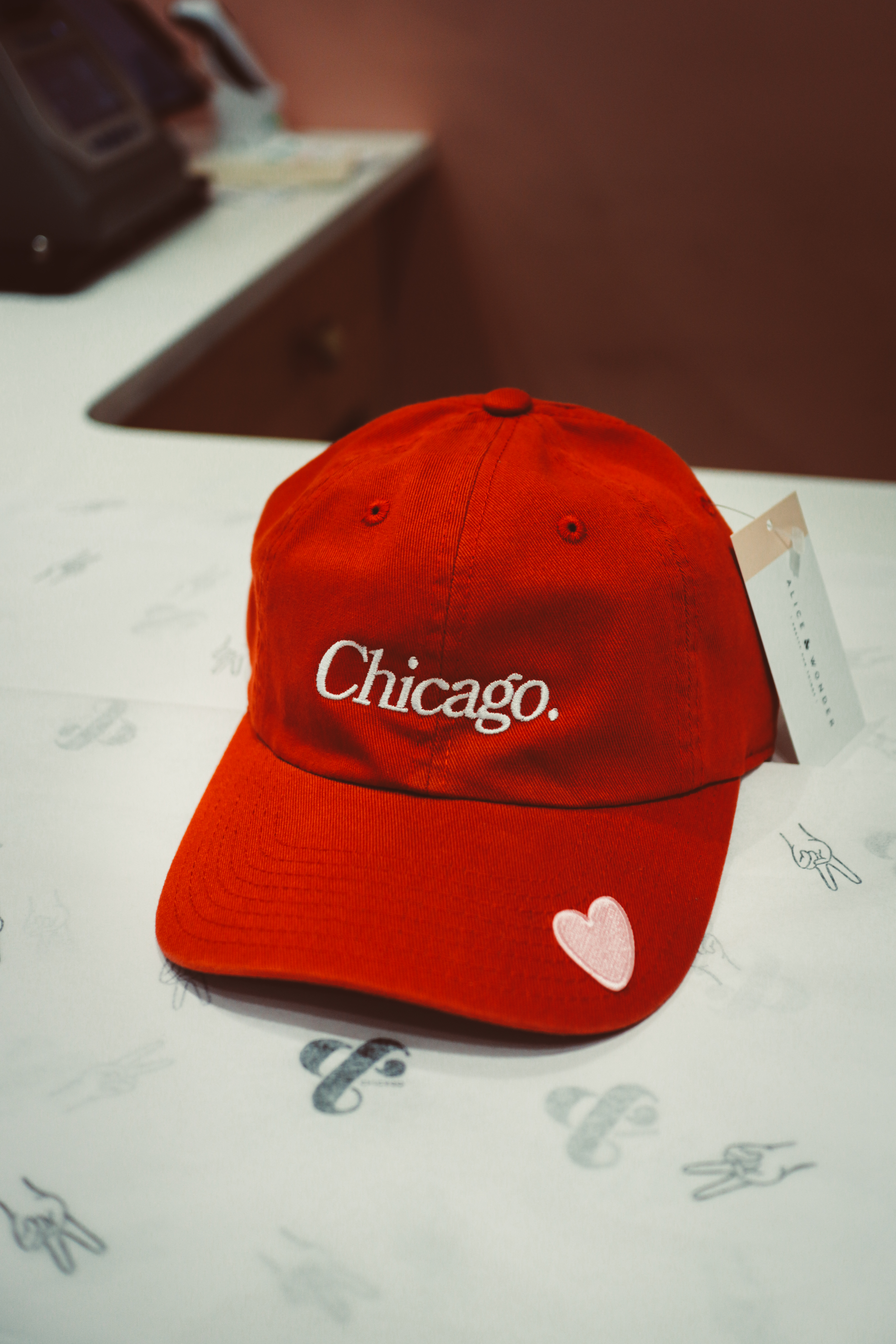 Red embroidered Chicago hat — small pink heart patch on brim