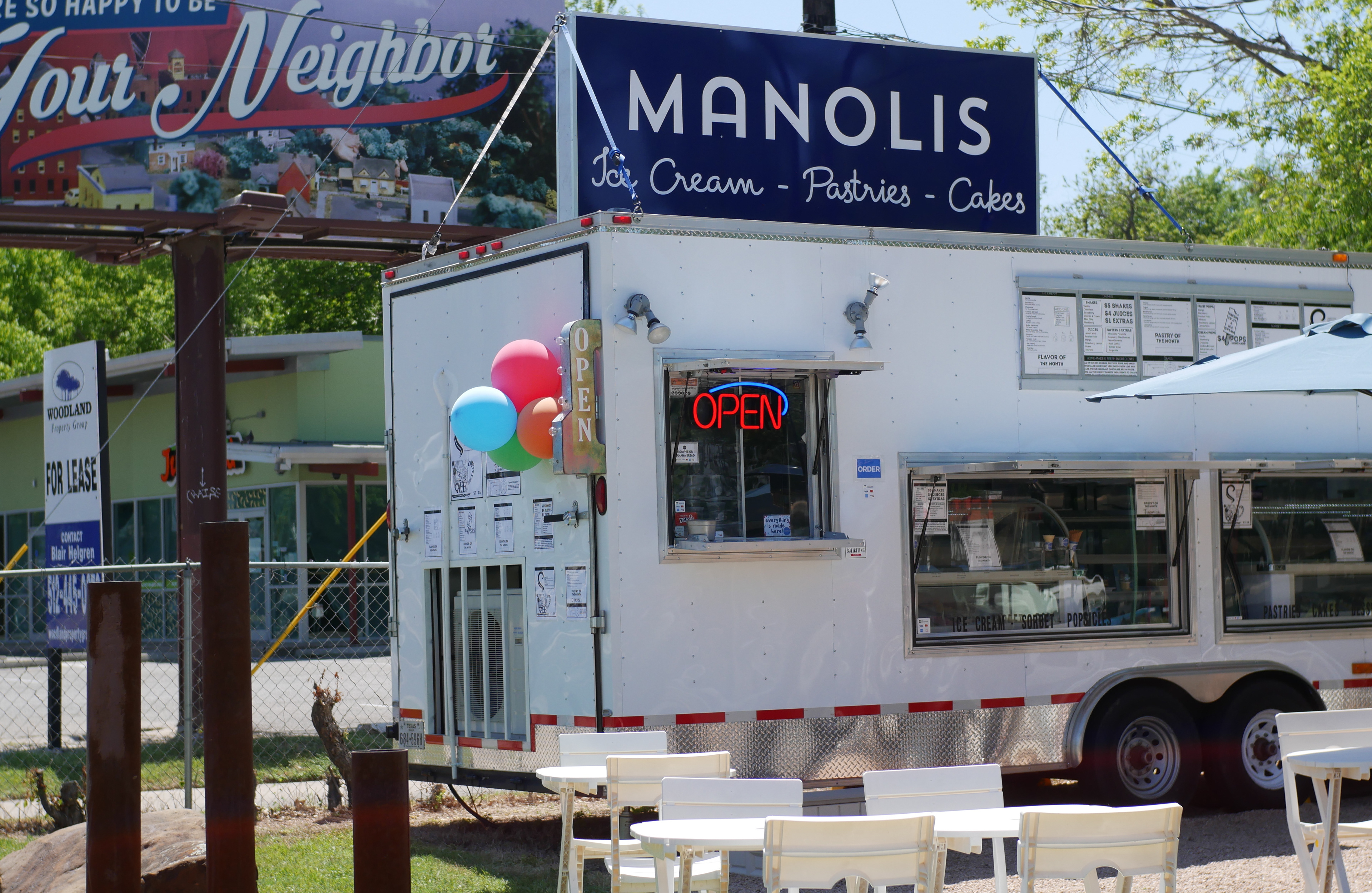 Manolis banner on truck — daytime