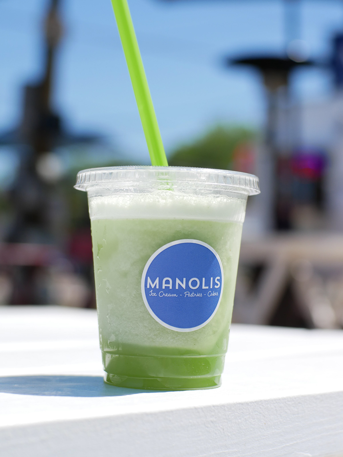 Manolis sticker on green drink